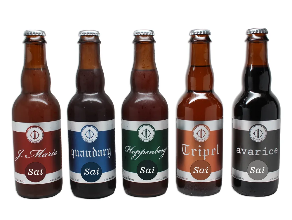 Five craft beer bottles with metallised BOPP labels in red, blue, green, copper and grey